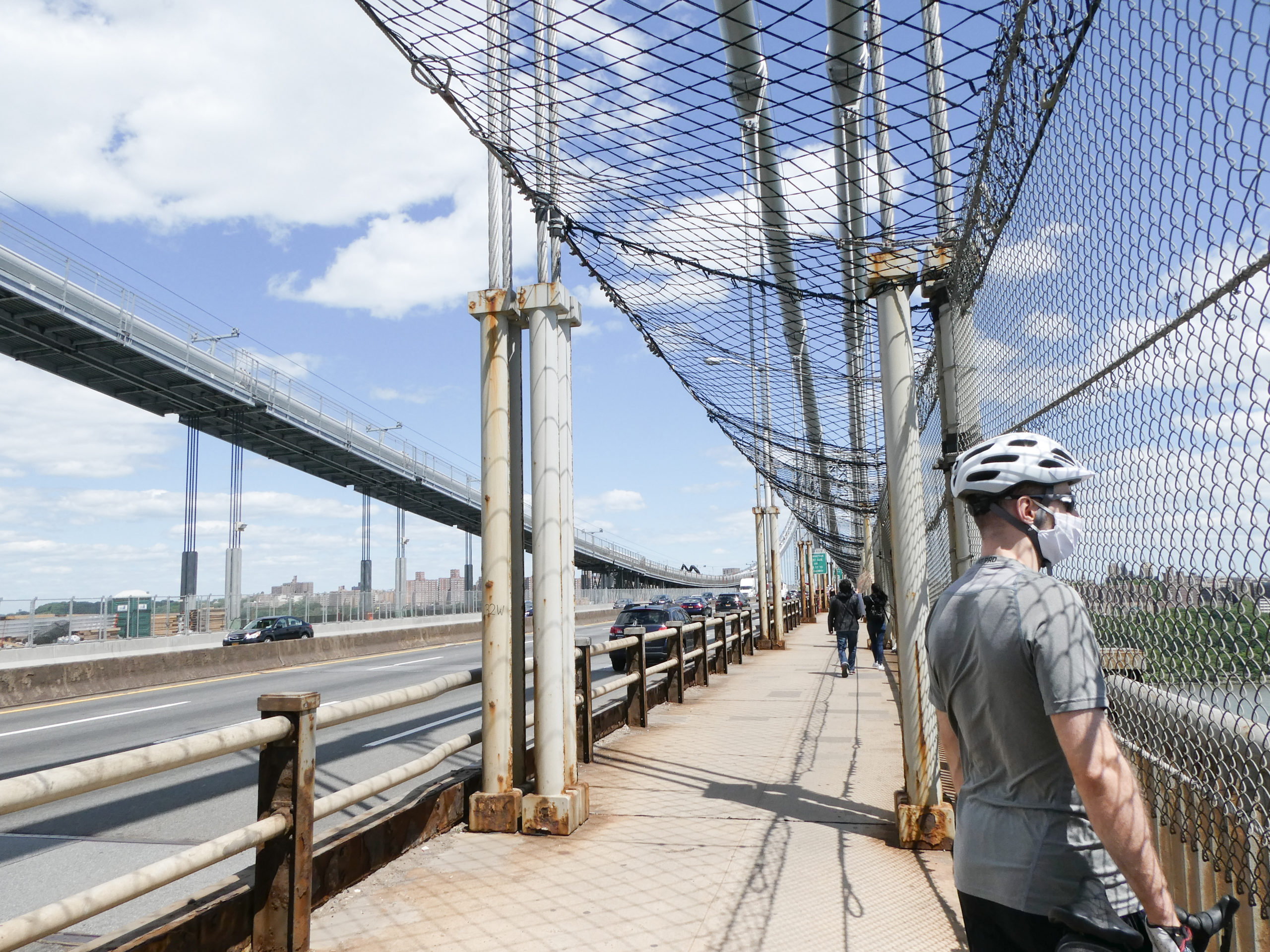 A man standing on the George Washington Bridge 