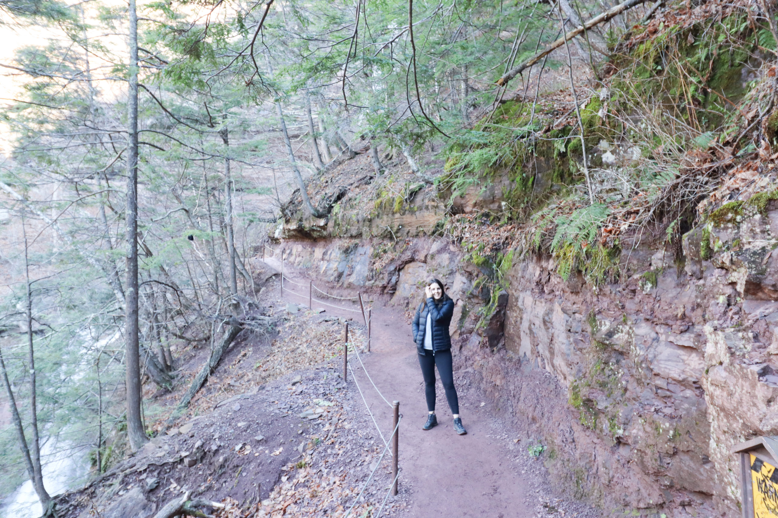 Woman standing on a trail on Kaaterskill Falls hike