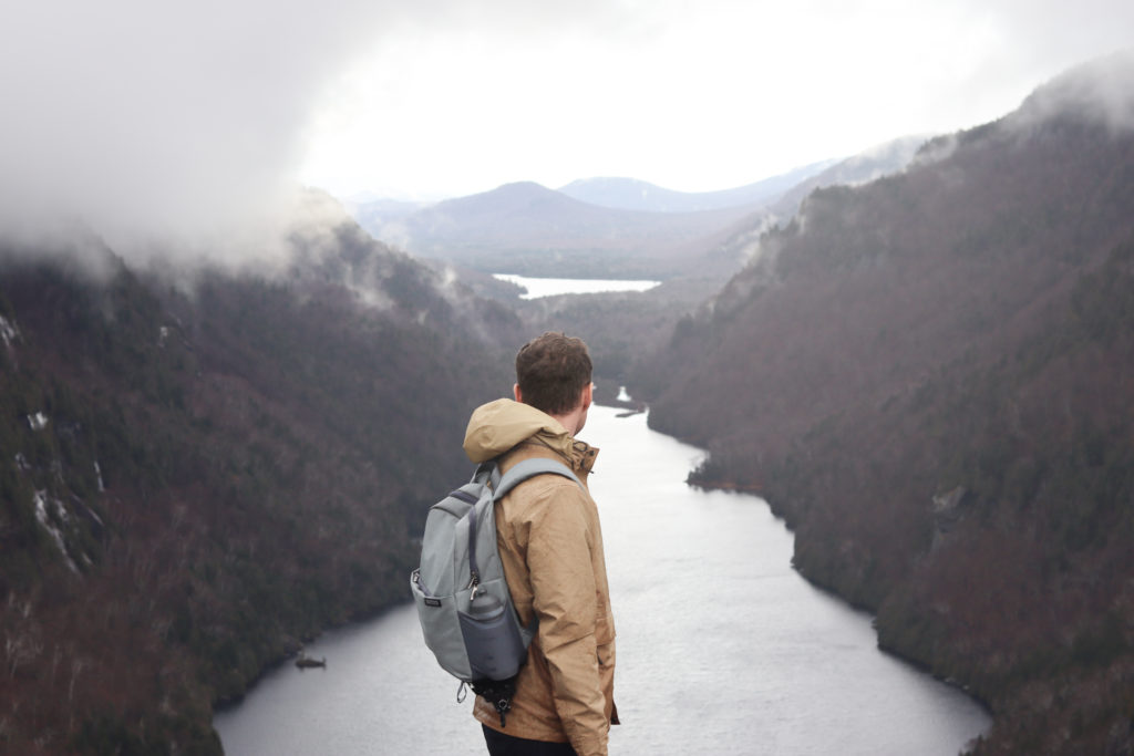 Man standing at the summit of Indian Head Hike