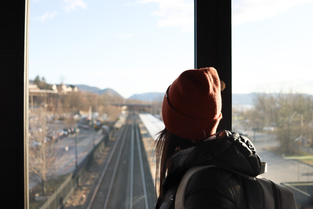 A women looking at the Hudson, NY train platform after a weekend road trip.