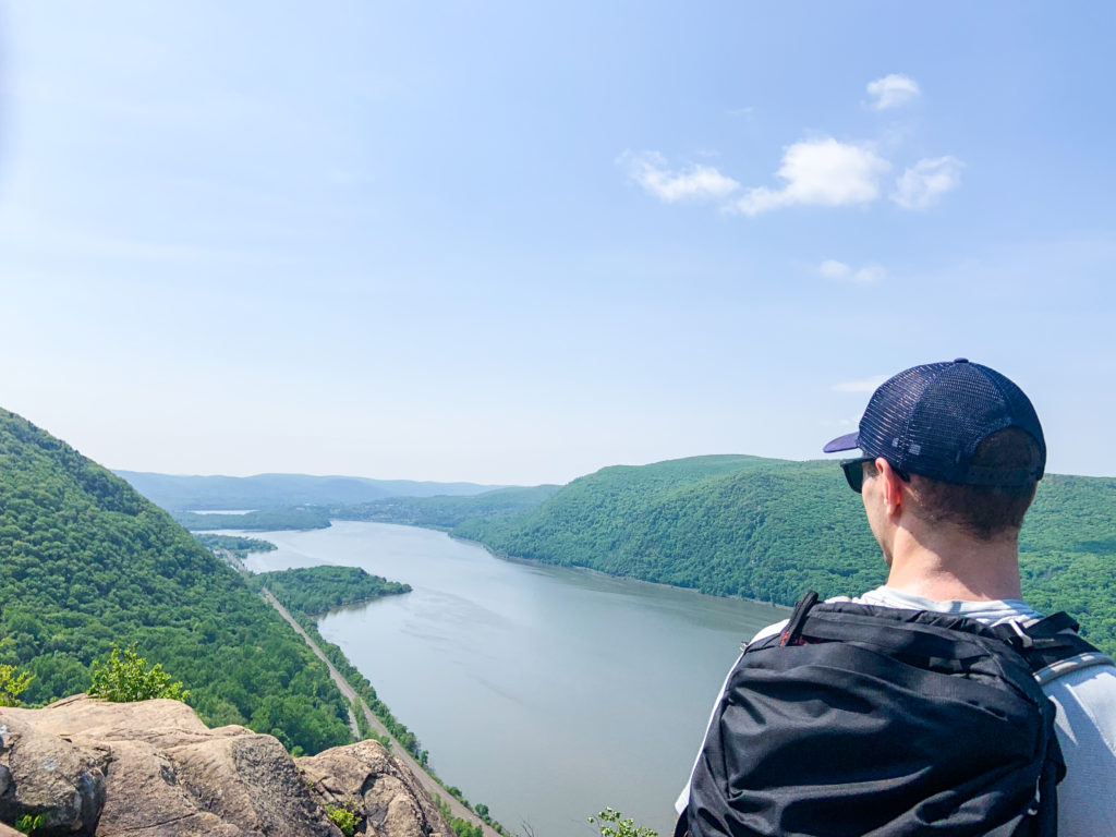 Man standing at summit of Breakneck Ridge trail