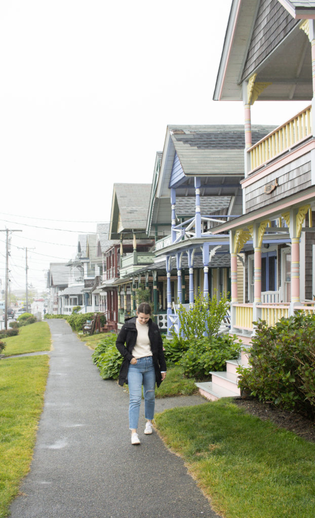 Woman standing in front of colorful house in Oak Bluffs, Martha's Vineyard