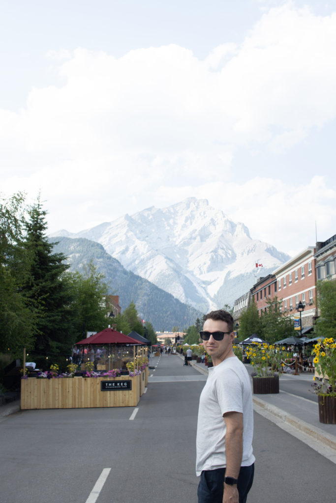 Man standing on Banff Avenue in in Banff National Park