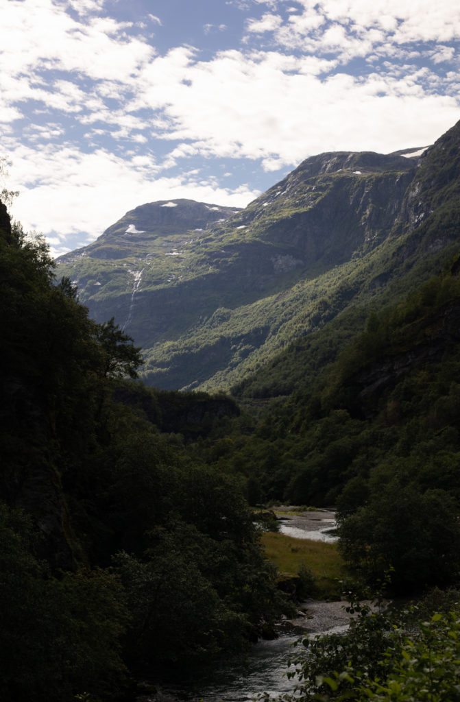 A view down a valley with a river in the center in Flåm Norway